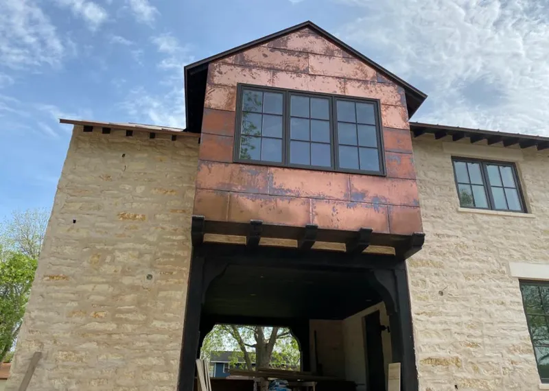 Copper metal panel facade on a stone building for Skylight Installation in Port Washington