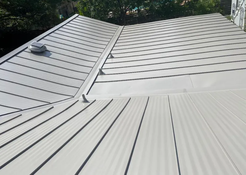 Solar attic fan installed on a metal roof for Roof Ventilation in Port Washington